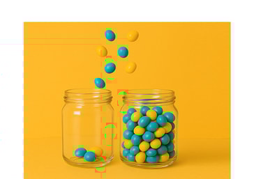Two glass jars on a bright yellow background – one full, one nearly empty, with blue and yellow balls falling into the emptier jar.