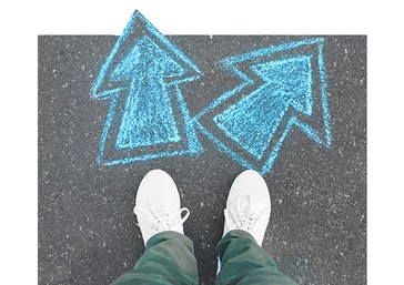 White trainers on tarmac beside two blue chalk arrows pointing in different directions, representing Fleximize’s impartial approach to business funding, helping SMEs find the most suitable lender, even if it’s not us.